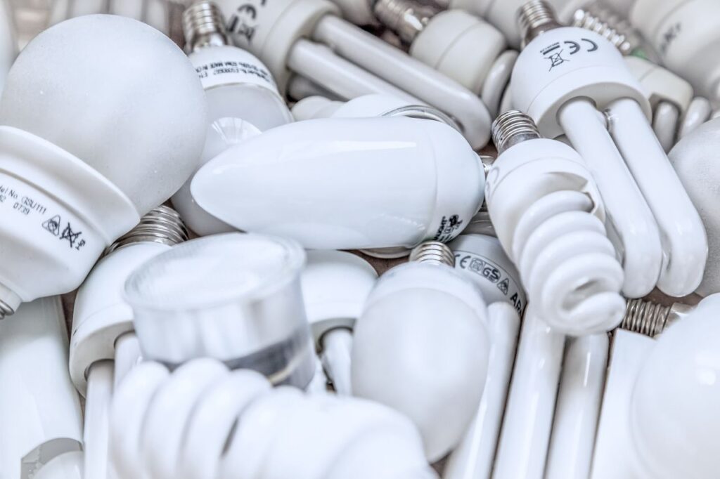 Pile of diverse energy-efficient light bulbs showcasing an array of designs and functionalities.